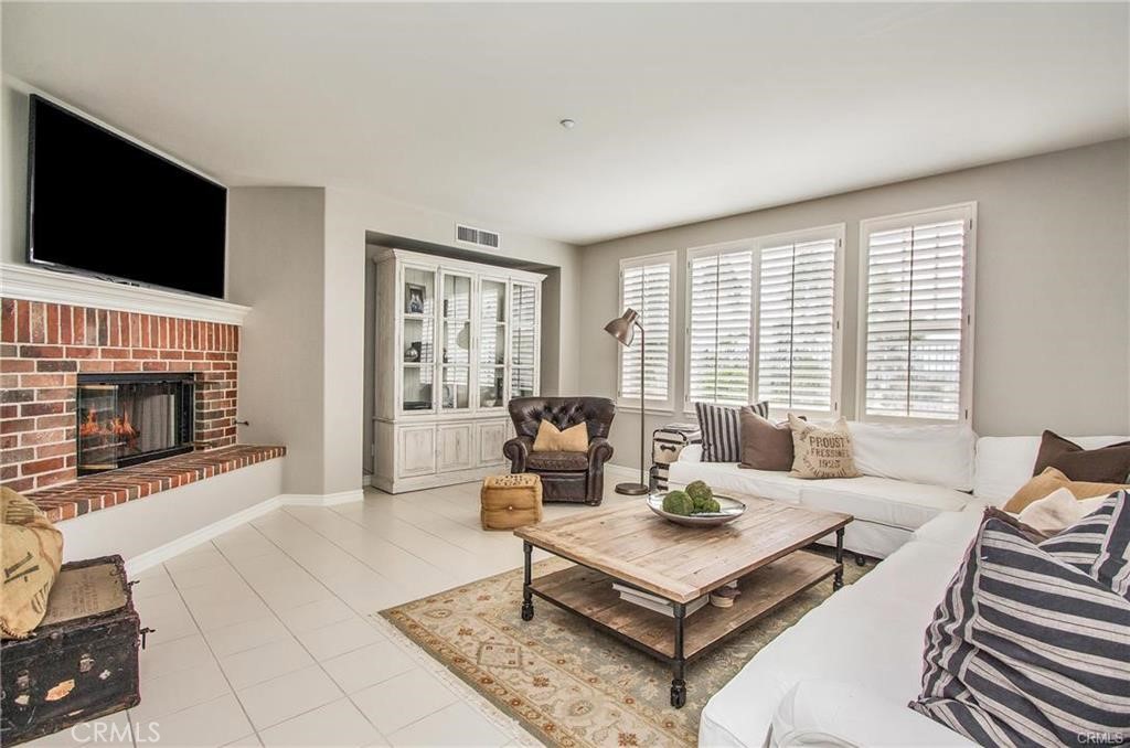 3 Weldon Heights Ladera Ranch, CA 92694 - Photo 4 of 13 a living room with furniture a flat screen tv and a fireplace