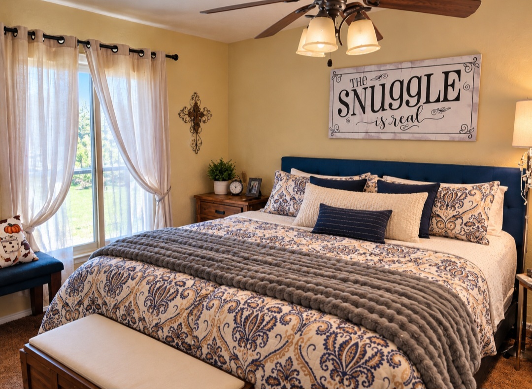 12526 3520th Road Seminole, OK 74868 - Photo 14 of 42 Window with light-filtering curtains, overhead ceiling fan with lighting, wood-finish nightstand, upholstered headboard, and soft-toned wall paint