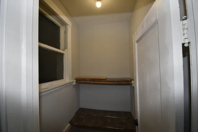a view of storage and utility room with wooden floor