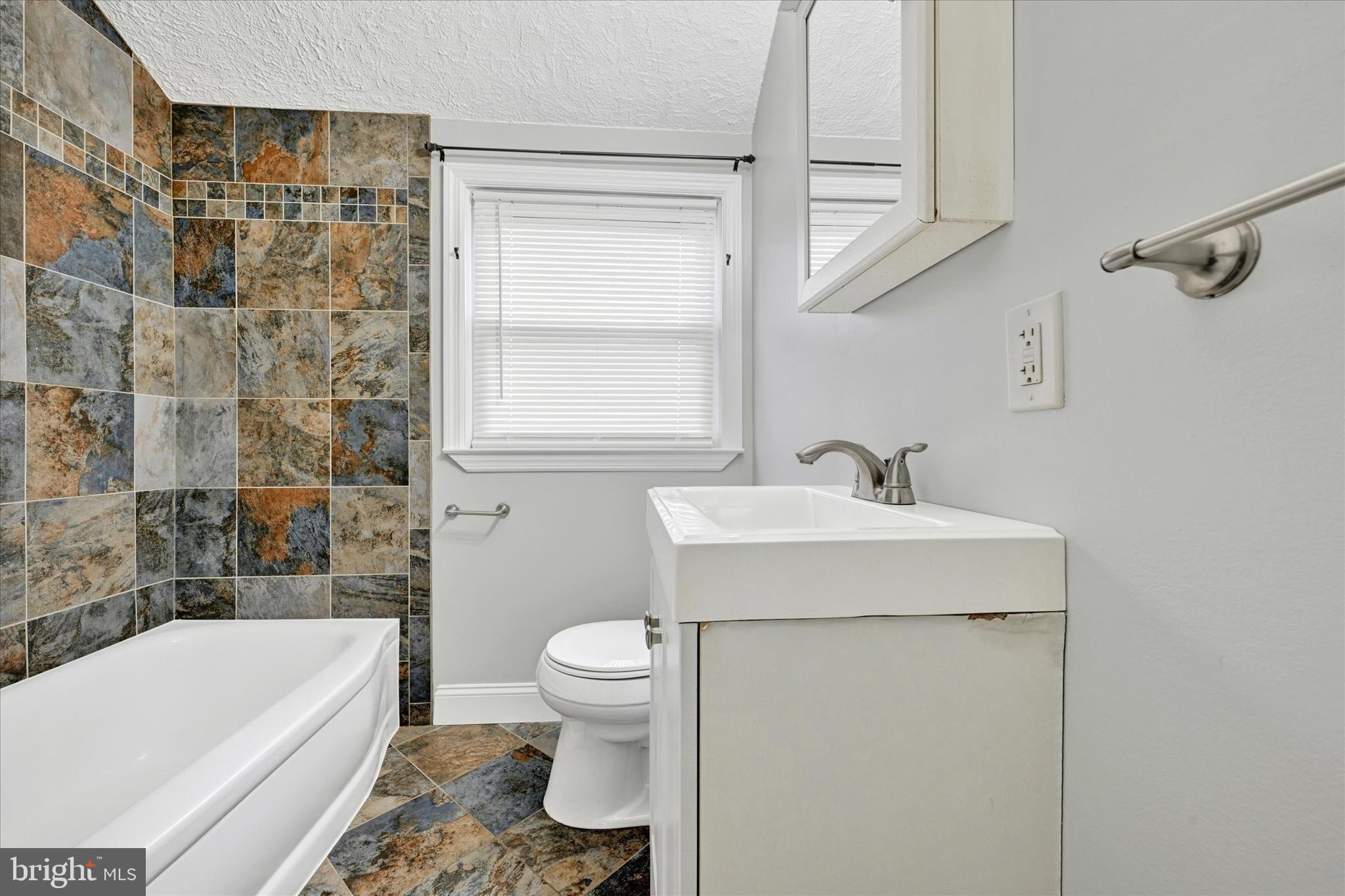 2013 Wareham Road Baltimore, MD 21222 - Photo 12 of 17 a bathroom with a sink toilet and shower