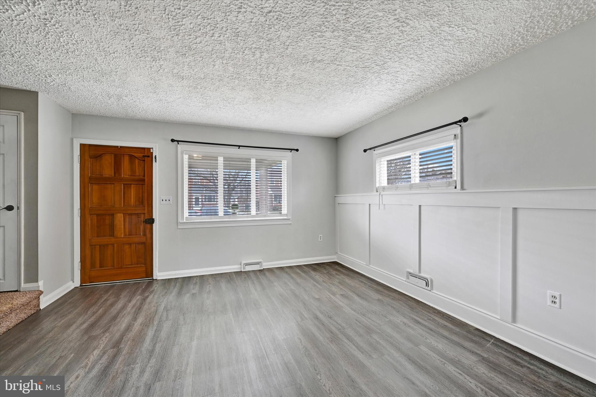 2013 Wareham Road Baltimore, MD 21222 - Photo 2 of 17 an empty room with wooden floor and windows