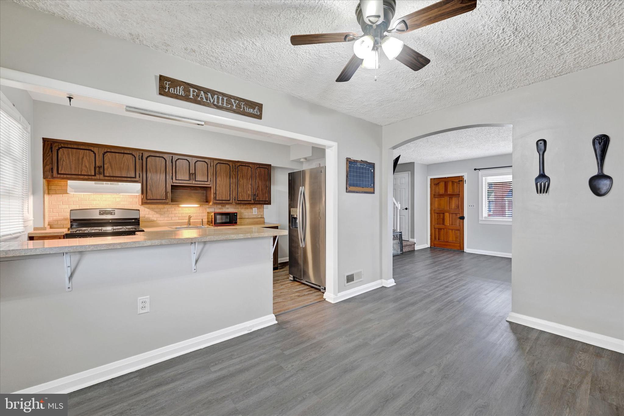 2013 Wareham Road Baltimore, MD 21222 - Photo 5 of 17 a kitchen with stainless steel appliances granite countertop a refrigerator a stove and a wooden floors