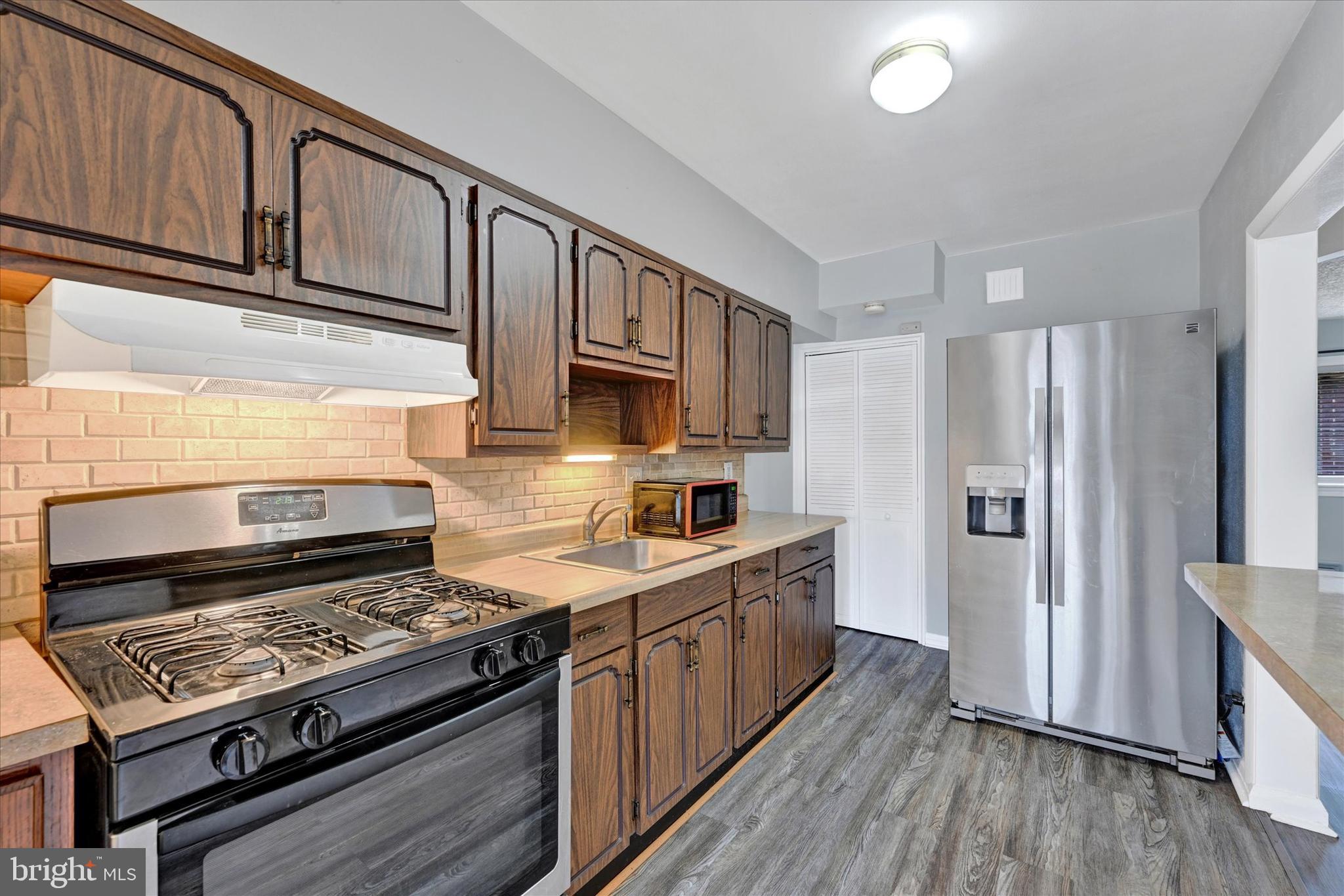2013 Wareham Road Baltimore, MD 21222 - Photo 8 of 17 a kitchen with stainless steel appliances granite countertop a stove and a refrigerator