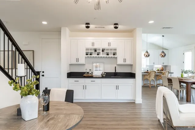 a kitchen with stainless steel appliances kitchen island granite countertop a table and chairs