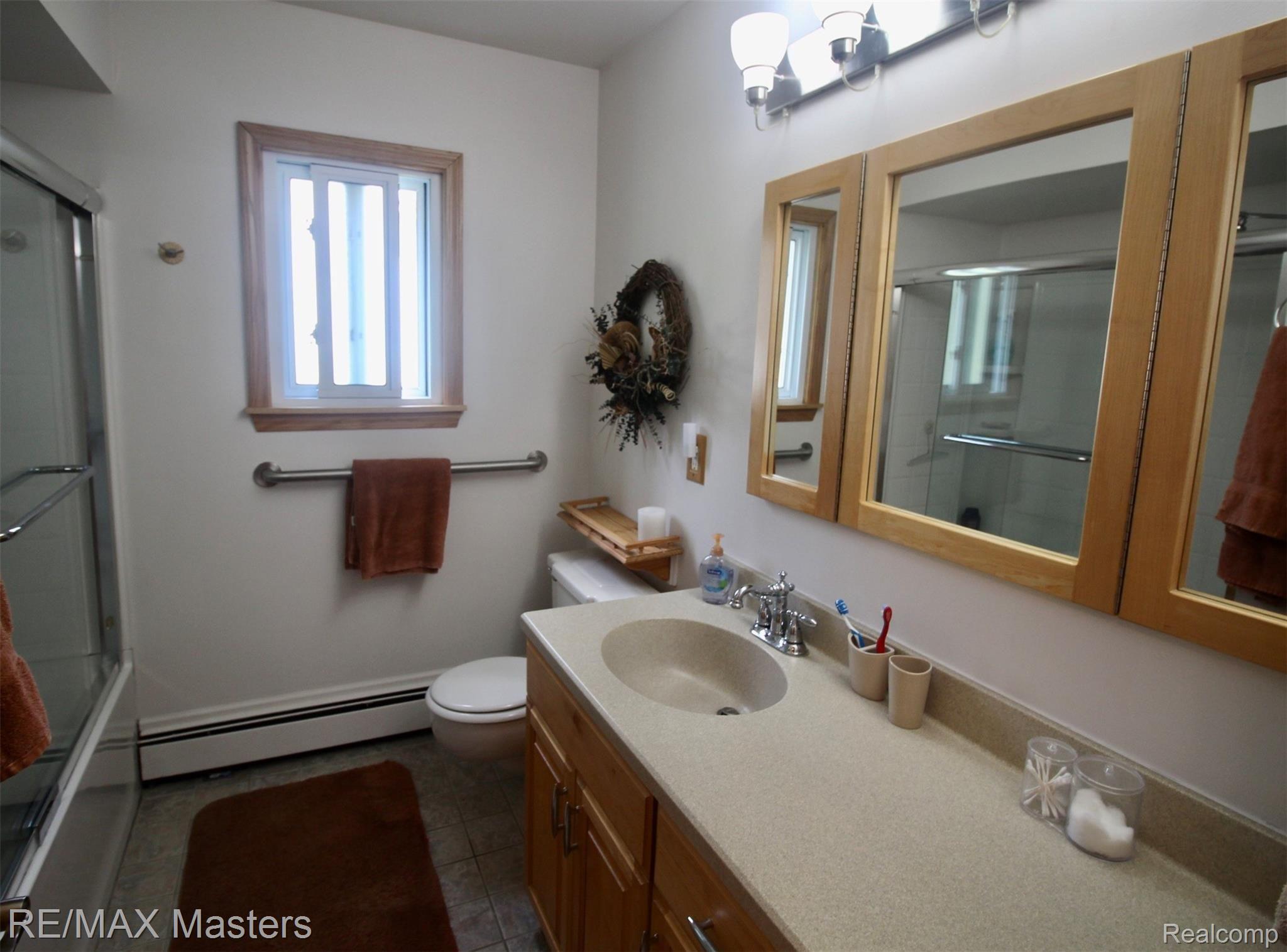 25777 Inkster Road Flat Rock, MI 48134 - Photo 30 of 52 The main bath has shower tub combination, large vanity and lots of storage and is located between the Jack and Jill type bedrooms at the rear of the bedroom wing of the house.