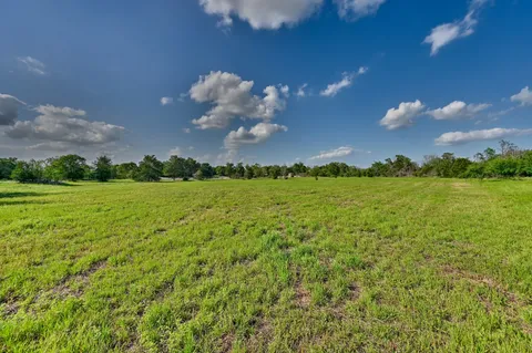 a view of a building with green field