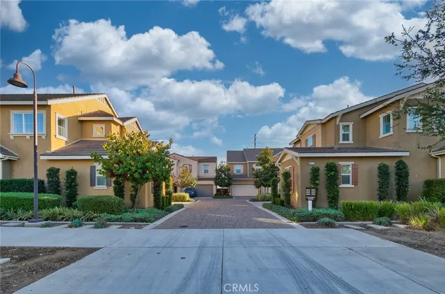 a row of palm trees in front of a building