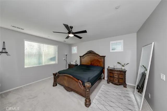 a spacious bathroom with a double vanity sink a mirror and a