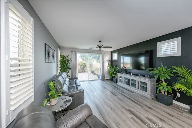 a kitchen with a sink appliances and wooden floor