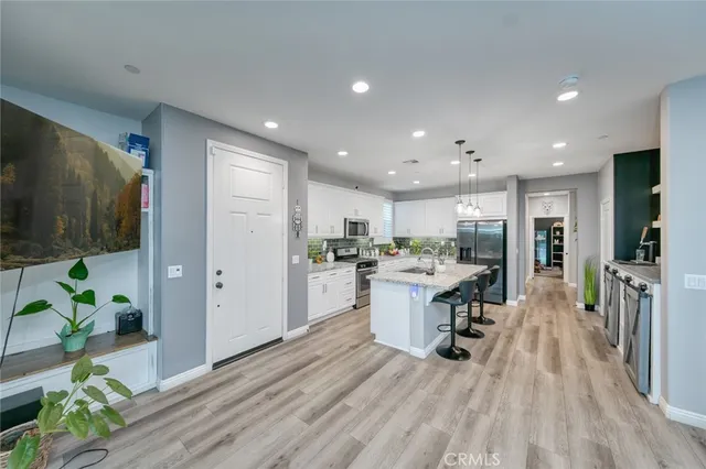 a kitchen with sink refrigerator and microwave