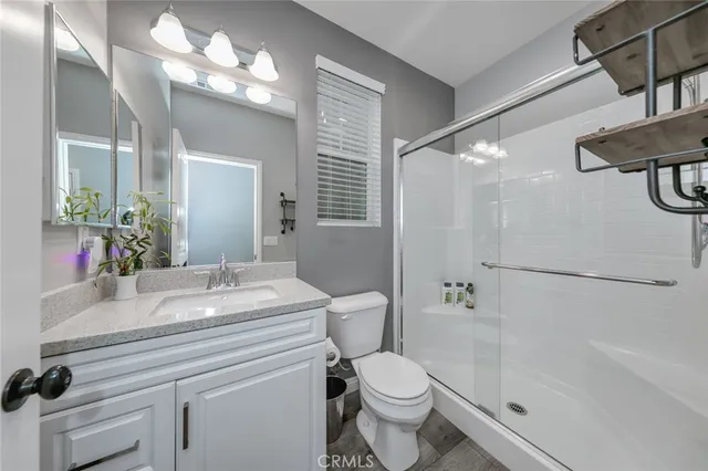 a kitchen with cabinets and wooden floor