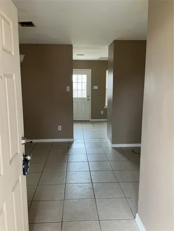 a view of a kitchen with an empty space and a window