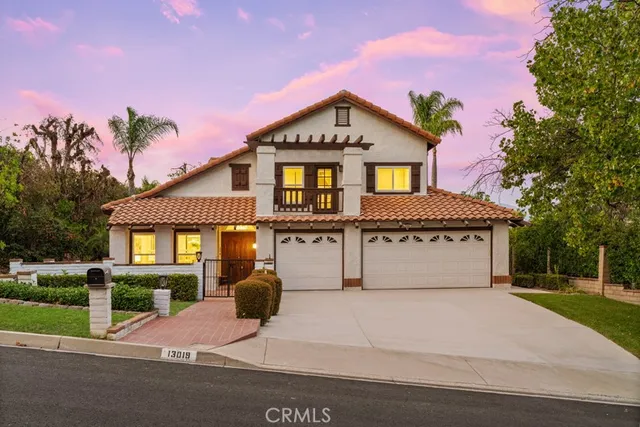 a kitchen with a table chairs microwave and cabinets