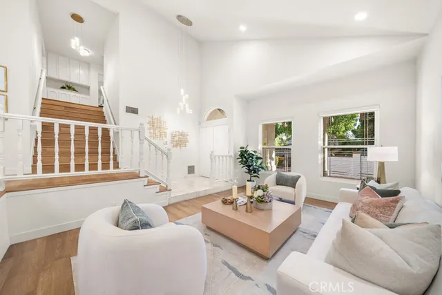 a kitchen with stainless steel appliances white cabinets and a window