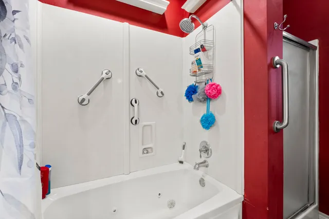 a living room with furniture a flat screen tv and kitchen view