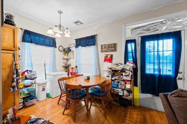 a dining room with furniture and chandelier