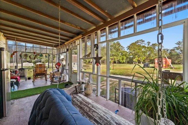 a living room with furniture and a floor to ceiling window