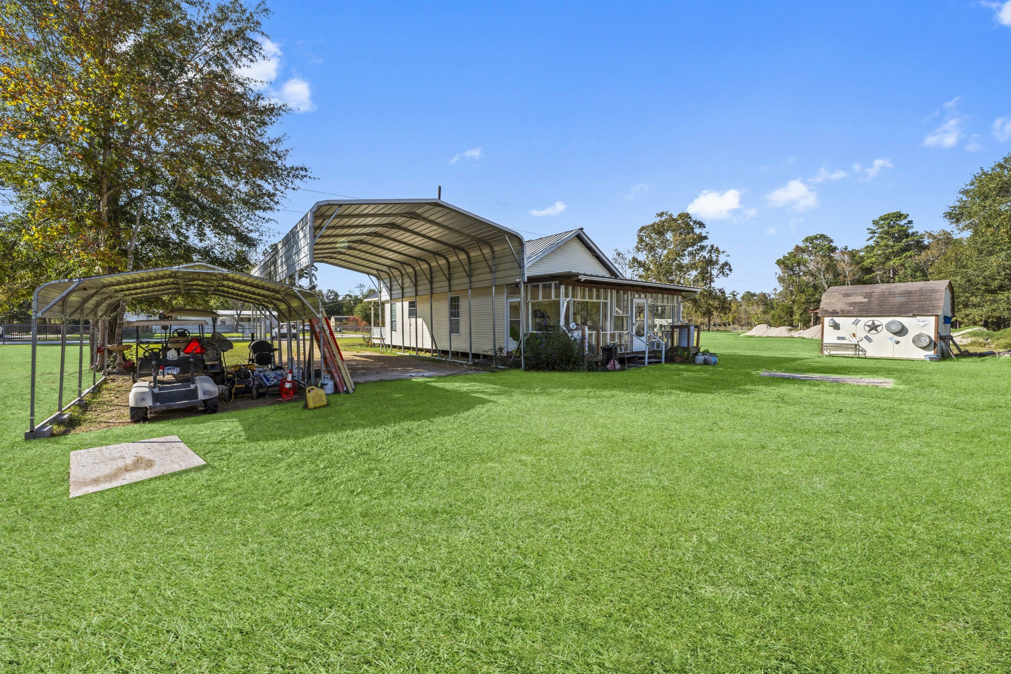 14991 North Tram Road Splendora, TX 77372 - Photo 24 of 40 a front view of a house with garden and trees