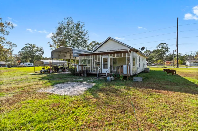 a view of a backyard with a garden and entertaining space