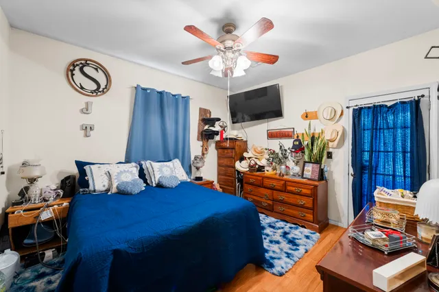 a bedroom with a bed and a chandelier