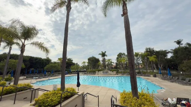 a front view of a white building with a yard