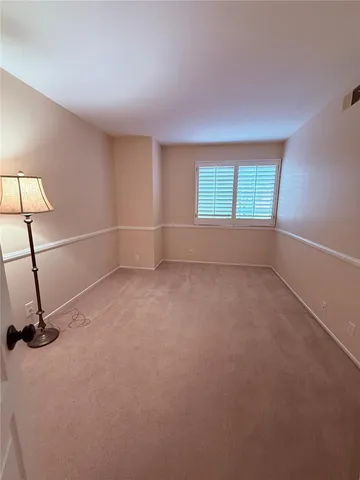 an empty room with a empty space and windows