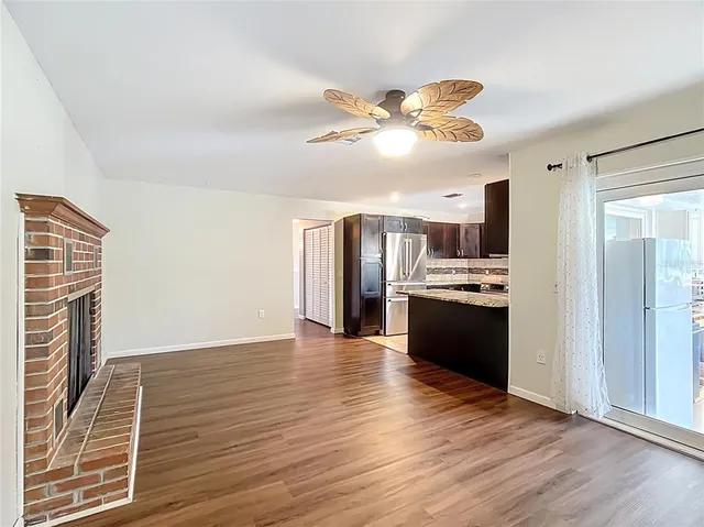 a view of a kitchen with a sink and a refrigerator
