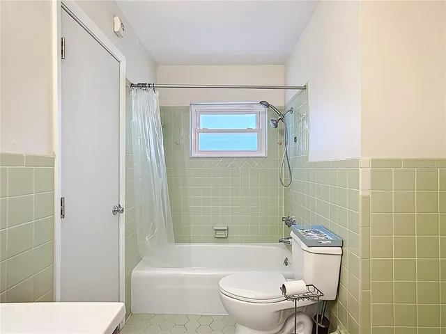a bathroom with a toilet a sink and shower