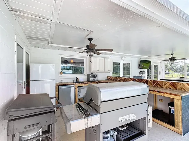 a kitchen with a stove a refrigerator and a fireplace