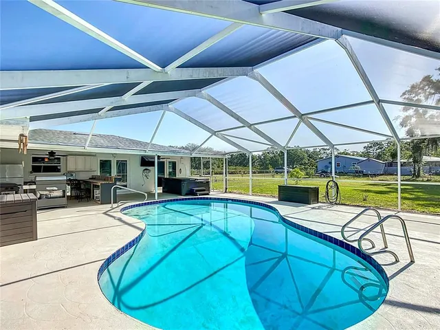 a view of a swimming pool with a patio