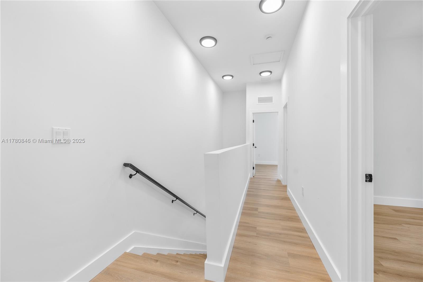 2121 Northwest 45th Street, Unit 2123 Miami, FL 33142 - Photo 12 of 24 a view of a hallway with wooden floor and staircase