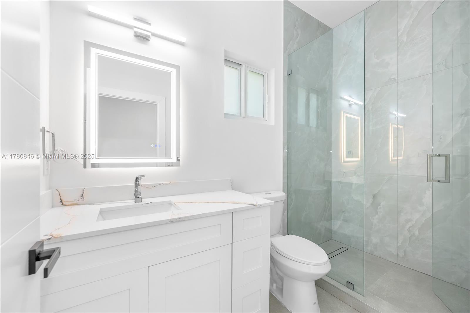 2121 Northwest 45th Street, Unit 2123 Miami, FL 33142 - Photo 14 of 24 a bathroom with a sink toilet and shower