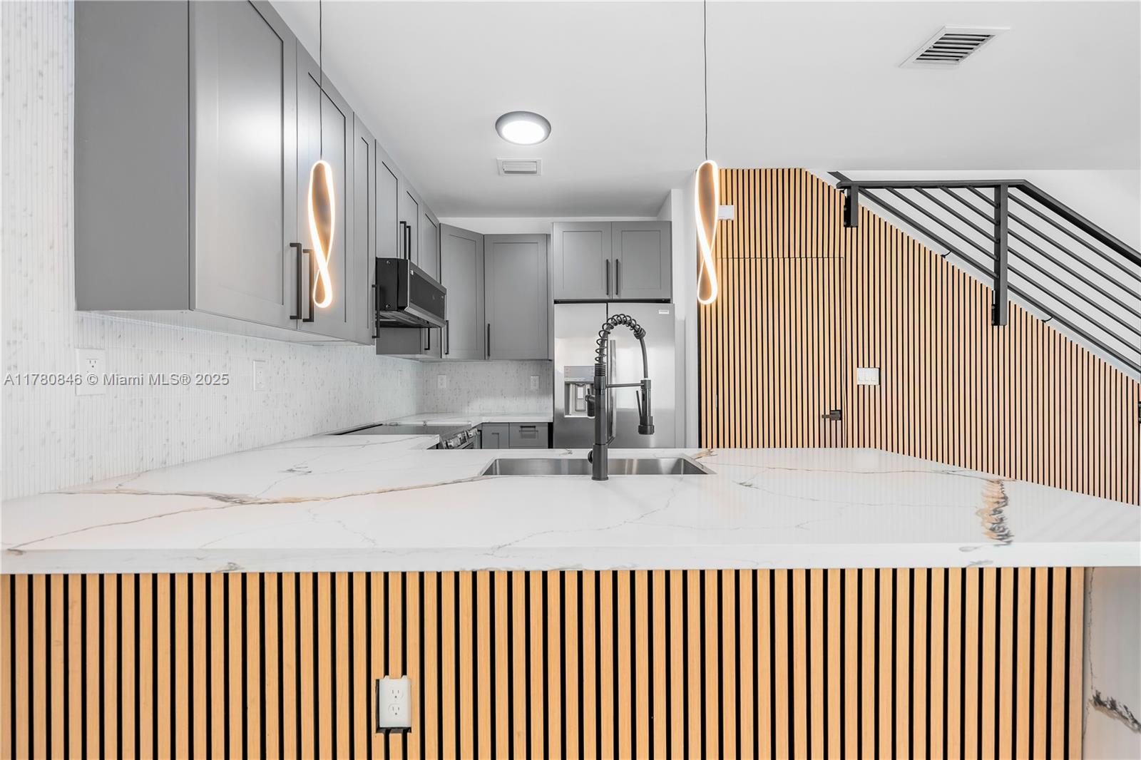 2121 Northwest 45th Street, Unit 2123 Miami, FL 33142 - Photo 2 of 24 a kitchen with a sink and a refrigerator