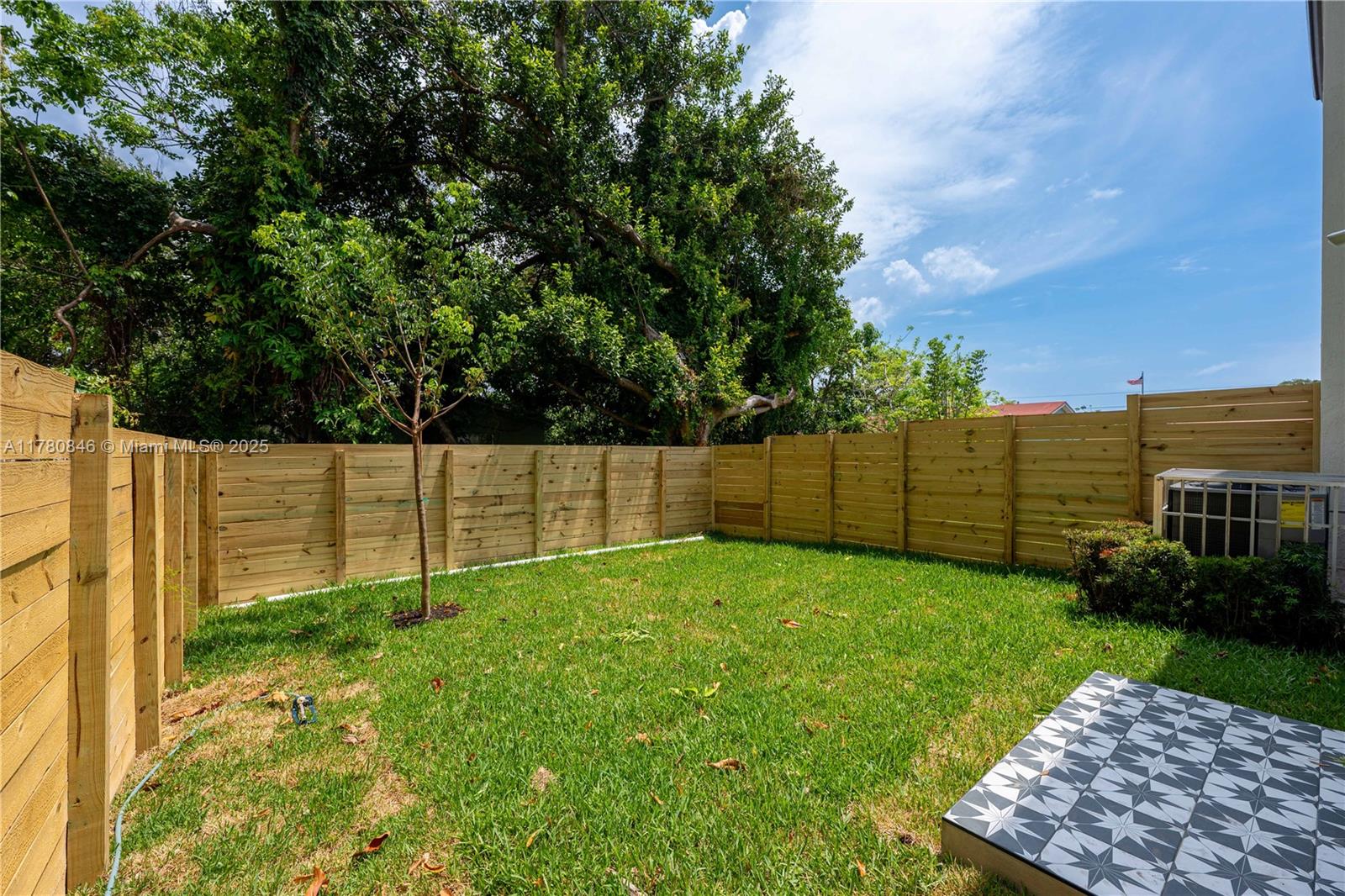 2121 Northwest 45th Street, Unit 2123 Miami, FL 33142 - Photo 21 of 24 a view of a backyard