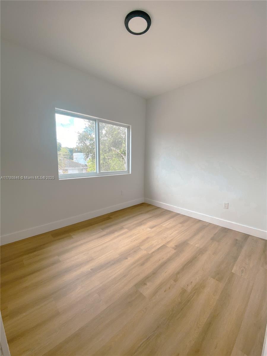 2121 Northwest 45th Street, Unit 2123 Miami, FL 33142 - Photo 7 of 24 an empty room with a window