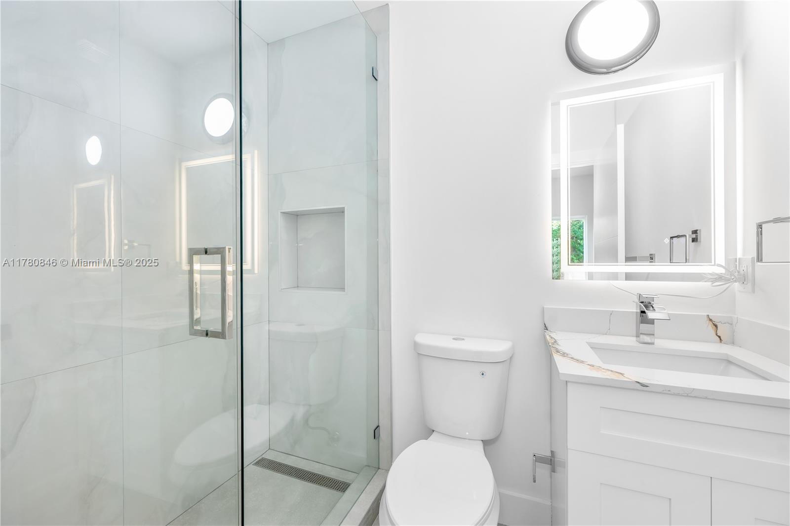 2121 Northwest 45th Street, Unit 2123 Miami, FL 33142 - Photo 10 of 24 a bathroom with a sink a toilet and shower