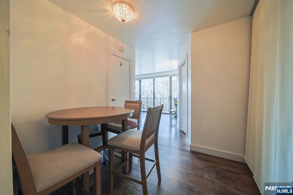 277 Prospect Avenue, Unit 4A Hackensack, NJ 07601 - Photo 15 of 27 a view of a dining room with furniture and wooden floor
