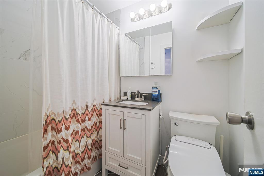 277 Prospect Avenue, Unit 4A Hackensack, NJ 07601 - Photo 16 of 27 a bathroom with a sink toilet and shower
