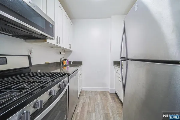 a kitchen with a stove and a refrigerator