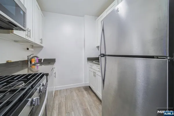 a kitchen with a refrigerator and a stove