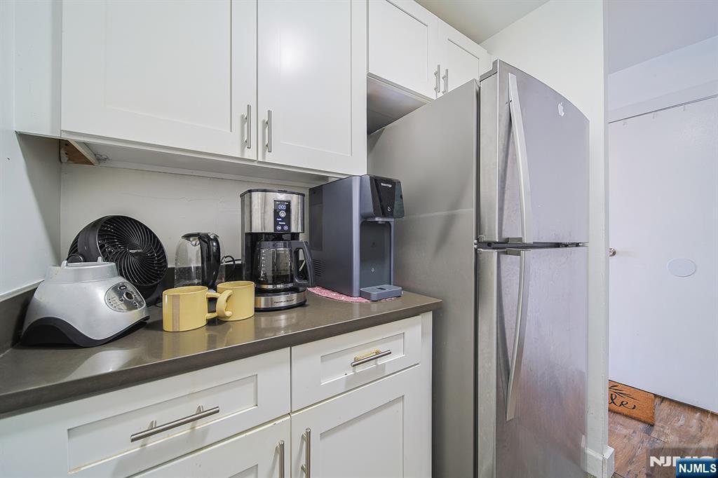 277 Prospect Avenue, Unit 4A Hackensack, NJ 07601 - Photo 20 of 27 a kitchen with a sink and cabinets