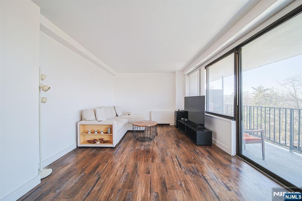 277 Prospect Avenue, Unit 4A Hackensack, NJ 07601 - Photo 2 of 27 a room with a bed and wooden floor