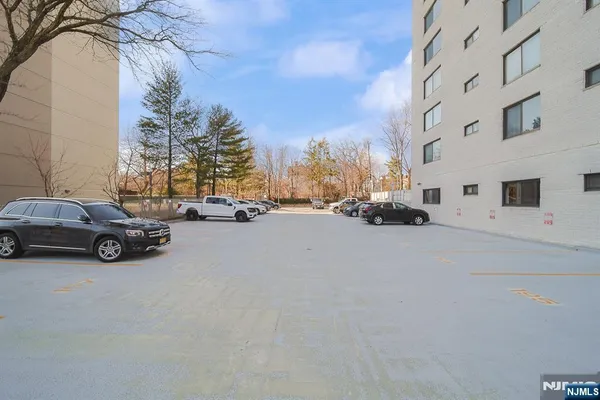 a view of car parked on the side of a street