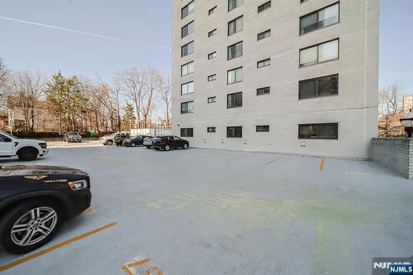 a view of a street that has couple of cars parked in front of it