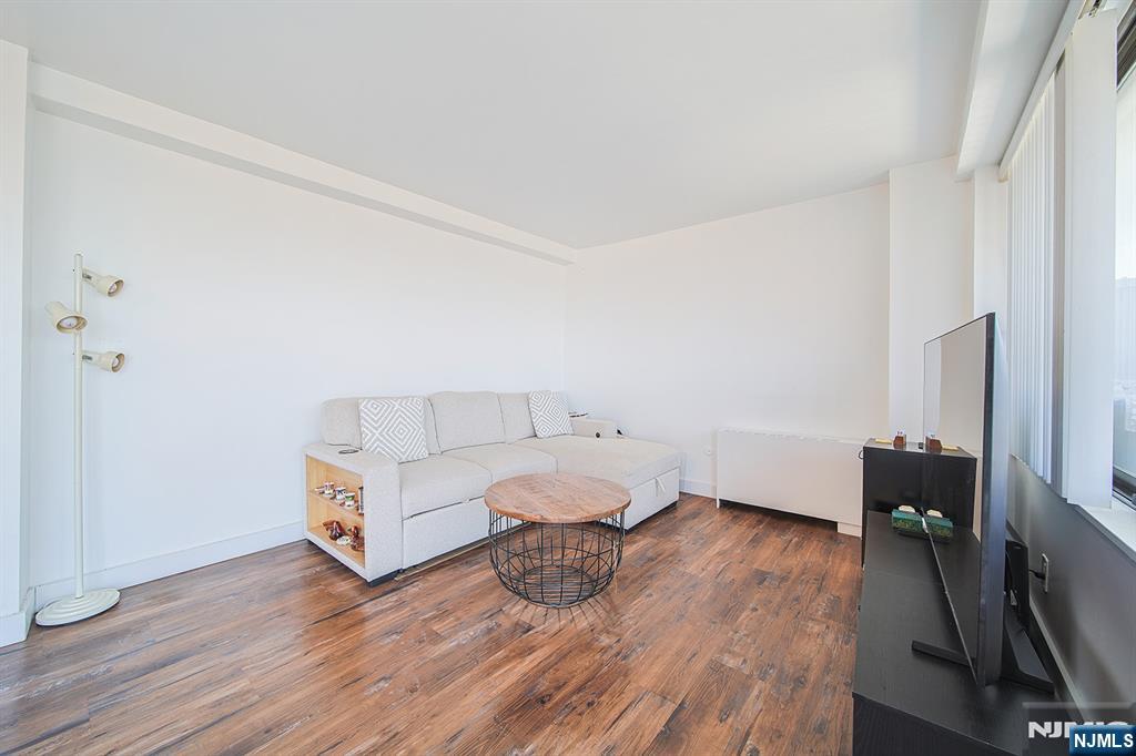 277 Prospect Avenue, Unit 4A Hackensack, NJ 07601 - Photo 7 of 27 a living room with furniture and a wooden floor