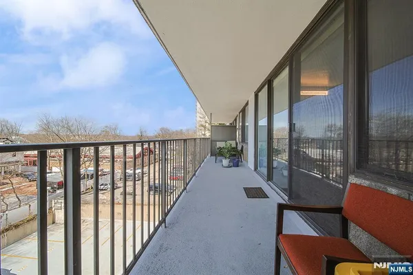 a view of a city from a balcony with furniture
