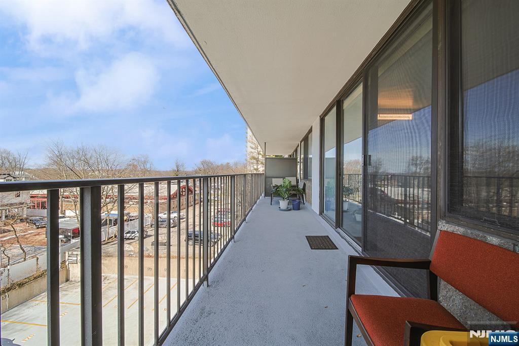 277 Prospect Avenue, Unit 4A Hackensack, NJ 07601 - Photo 9 of 27 a view of a city from a balcony with furniture