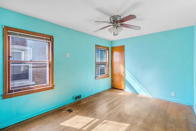 a view of a livingroom with a ceiling fan and window