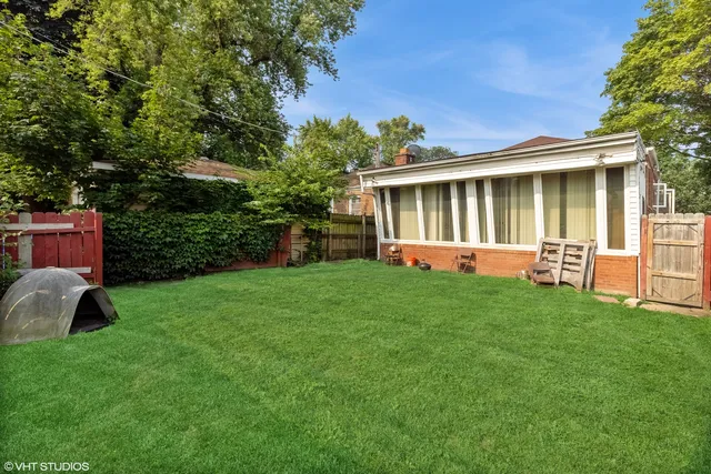a backyard of a house with table and chairs