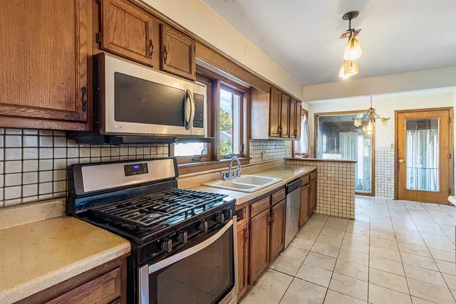 a kitchen with a stove a sink and a microwave